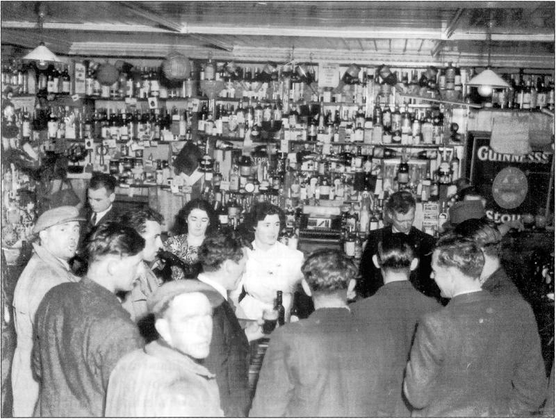 Title: 1948 - Extras from the film "Saints and Sinners" have a break at Doyle's. Description: Serving behind the bar are Joe Doyle, Maureen Treanor, Maureen Doyle, Jack Doyle and Louis Doyle (forehead only). Source: Omeath - A look at the past - Volume 2